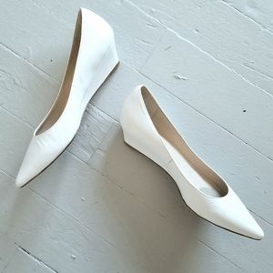 Elegant, white point-toe kitten wedges